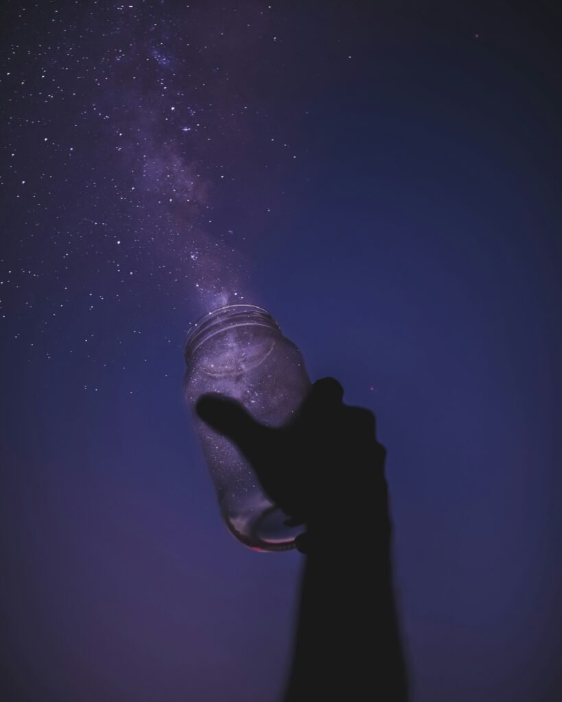 person holding glass jar